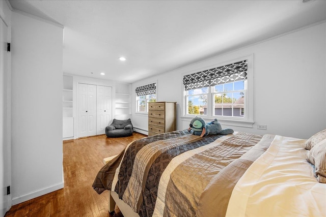 18 Stirrup Ln, Glen Cove, NY 11542 - bedroom with wood finished floors, a baseboard radiator, recessed lighting, a closet, and baseboards