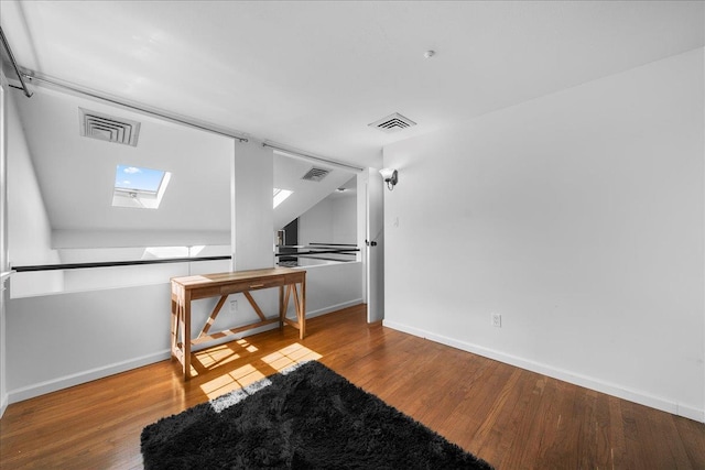 18 Stirrup Ln, Glen Cove, NY 11542 - spare room featuring a skylight, wood finished floors, and baseboards