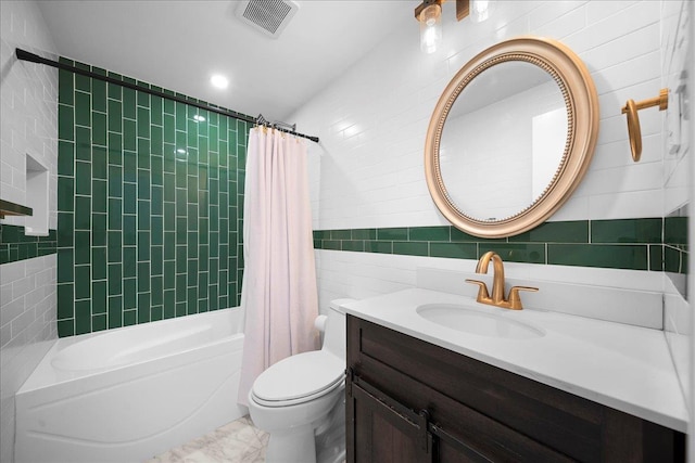 18 Stirrup Ln, Glen Cove, NY 11542 - bathroom with tile walls, shower / bath combo with shower curtain, vanity, toilet, and marble finish floors