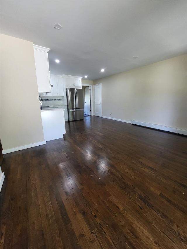 1017 Fire Island Ave, Bay Shore, NY 11706 - unfurnished living room featuring dark wood-style floors, baseboards, and recessed lighting