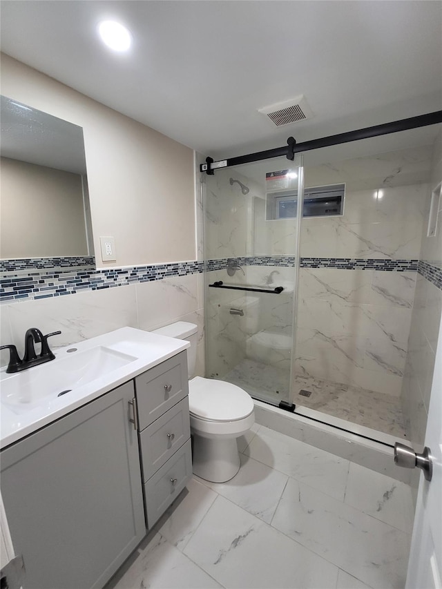 1017 Fire Island Ave, Bay Shore, NY 11706 - bathroom featuring a marble finish shower, vanity, toilet, marble finish flooring, and tile walls