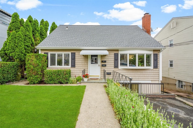 11 Parsons St, Harrison, NY 10528 - view of front of house with roof with shingles, a front lawn, and a chimney