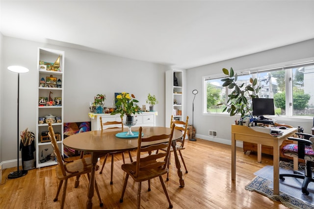 11 Parsons St, Harrison, NY 10528 - dining room with light wood-style floors, a desk, and baseboards