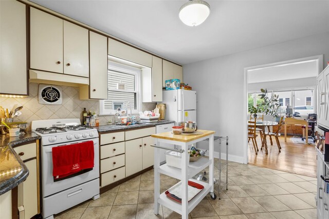 11 Parsons St, Harrison, NY 10528 - kitchen with white appliances, decorative backsplash, and healthy amount of natural light