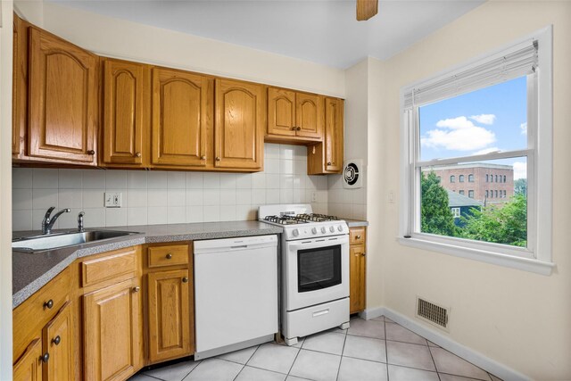 11 Parsons St, Harrison, NY 10528 - kitchen with white appliances, a sink, decorative backsplash, and brown cabinetry