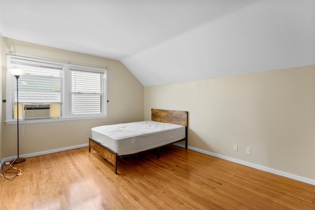 11 Parsons St, Harrison, NY 10528 - bedroom with wood finished floors, lofted ceiling, cooling unit, and baseboards
