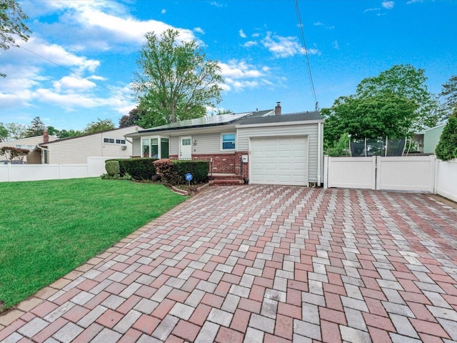 251 Woods Rd, North Babylon, NY 11703 - single story home with a garage, decorative driveway, brick siding, solar panels, and a chimney
