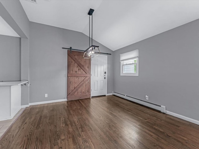 251 Woods Rd, North Babylon, NY 11703 - unfurnished dining area with baseboard heating, a barn door, vaulted ceiling, wood finished floors, and baseboards