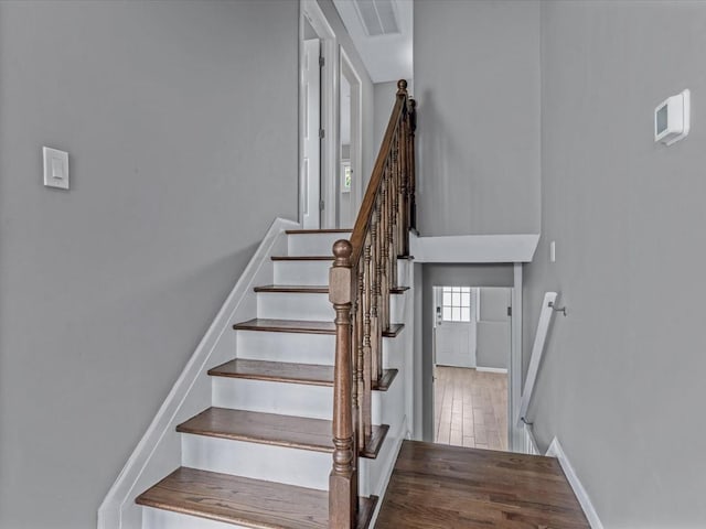 251 Woods Rd, North Babylon, NY 11703 - staircase featuring baseboards and wood finished floors