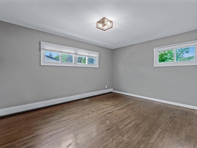 251 Woods Rd, North Babylon, NY 11703 - empty room featuring plenty of natural light, wood-type flooring, baseboards, and baseboard heating