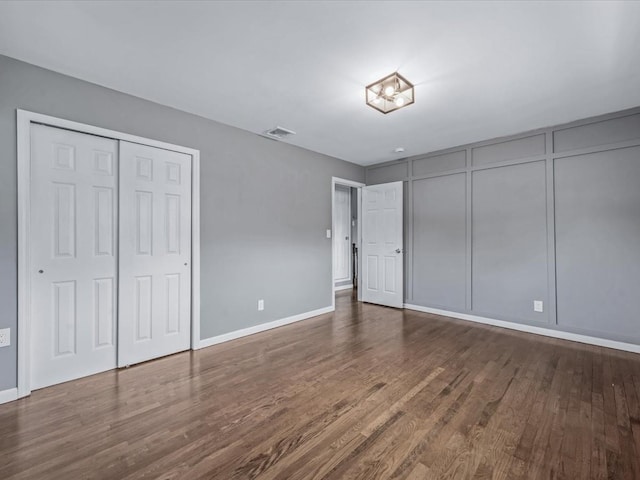 251 Woods Rd, North Babylon, NY 11703 - unfurnished bedroom featuring wood finished floors and baseboards