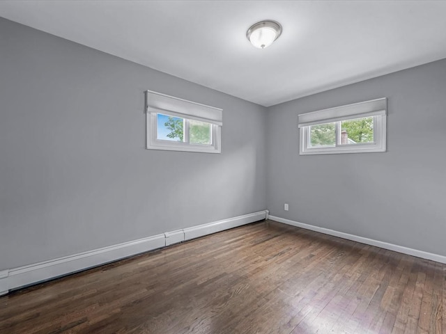 251 Woods Rd, North Babylon, NY 11703 - empty room with healthy amount of natural light, hardwood / wood-style floors, baseboards, and a baseboard radiator