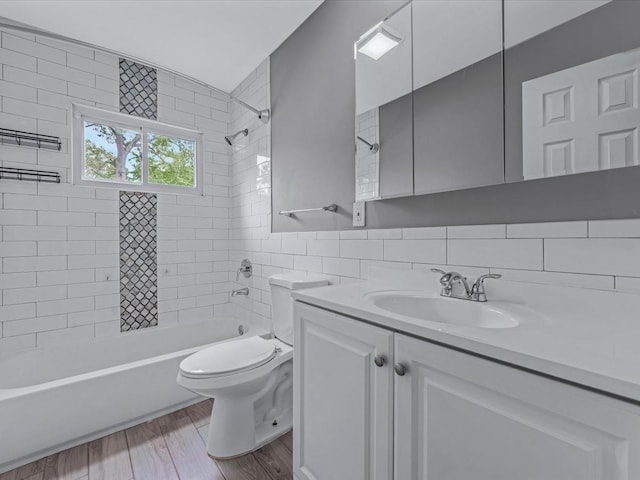 251 Woods Rd, North Babylon, NY 11703 - full bathroom featuring vanity, toilet, bathing tub / shower combination, wood finished floors, and tasteful backsplash