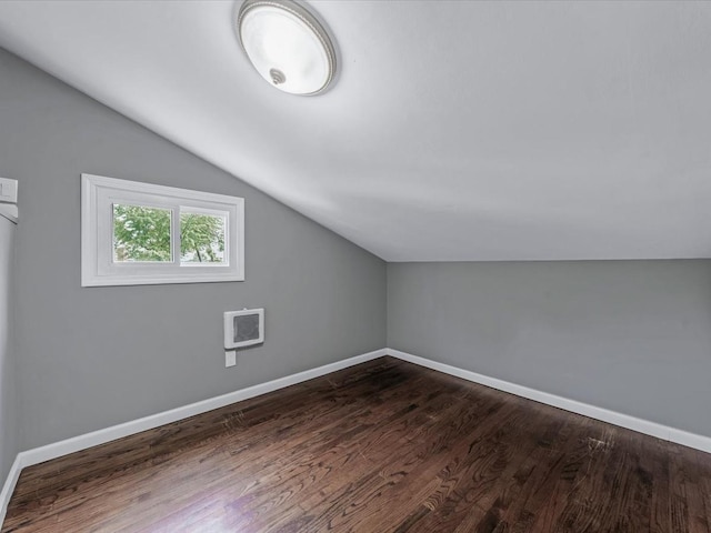 251 Woods Rd, North Babylon, NY 11703 - additional living space featuring vaulted ceiling, dark wood finished floors, and baseboards