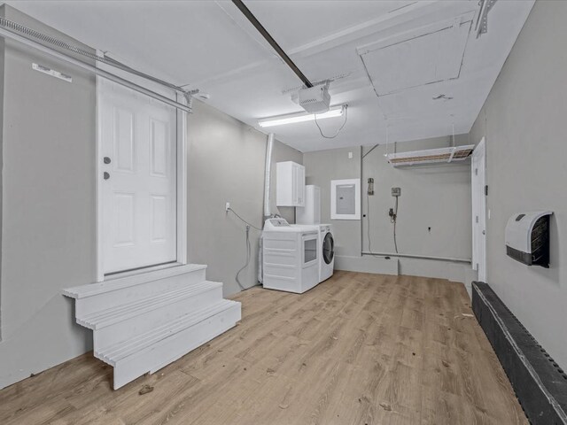 251 Woods Rd, North Babylon, NY 11703 - garage featuring electric panel, a garage door opener, and independent washer and dryer