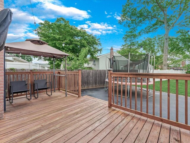251 Woods Rd, North Babylon, NY 11703 - wooden terrace with a trampoline and a gazebo