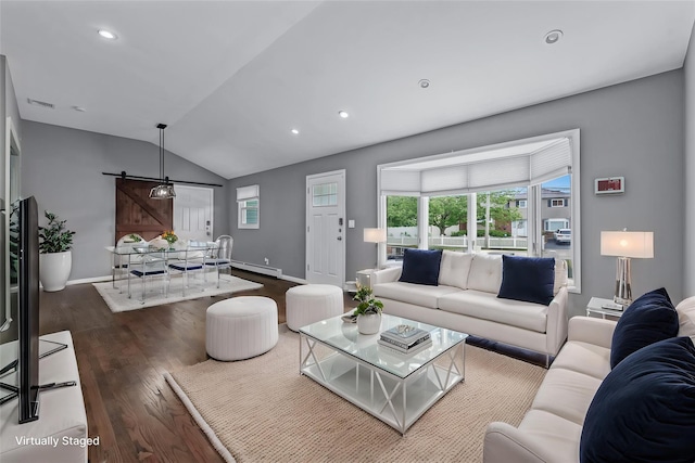 251 Woods Rd, North Babylon, NY 11703 - living area with wood finished floors, lofted ceiling, plenty of natural light, baseboards, and a barn door