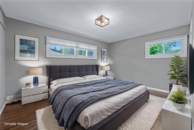 251 Woods Rd, North Babylon, NY 11703 - bedroom featuring multiple windows, wood finished floors, and baseboards