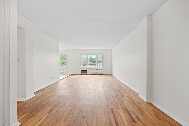 415 Gramatan Ave Unit 2C, Mount Vernon, NY 10552 - unfurnished living room with radiator, light wood-type flooring, and baseboards