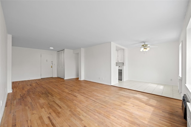 415 Gramatan Ave Unit 2C, Mount Vernon, NY 10552 - unfurnished living room featuring light wood-style floors, ceiling fan, and baseboards