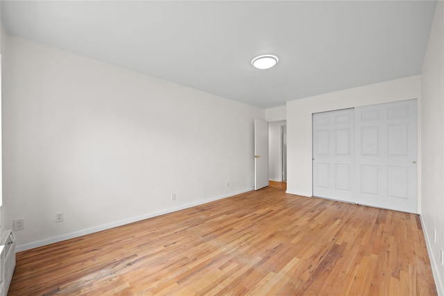 415 Gramatan Ave Unit 2C, Mount Vernon, NY 10552 - unfurnished bedroom with light wood-style flooring, a closet, and baseboards