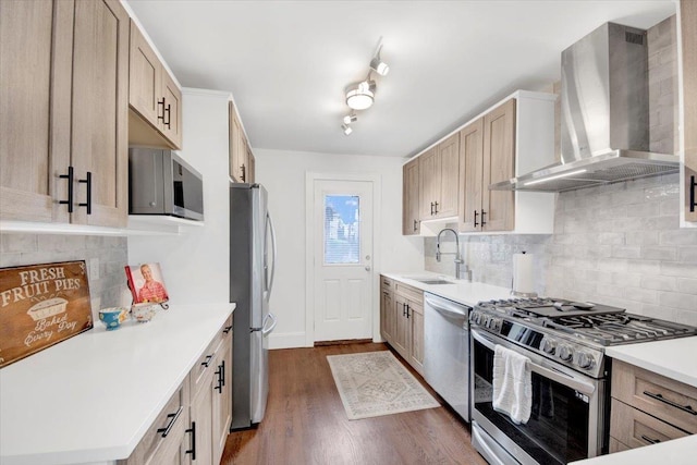 211 Bowne St, Bronx, NY 10464 - kitchen with appliances with stainless steel finishes, wall chimney exhaust hood, a sink, dark wood-style floors, and backsplash