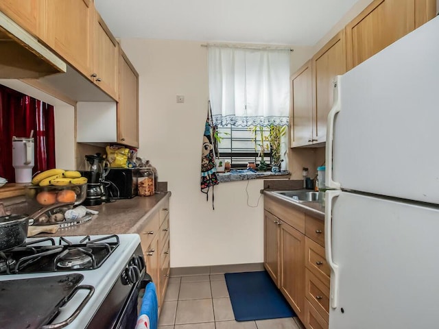 1347 Bristow St Unit 4B, Bronx, NY 10459 - kitchen with freestanding refrigerator, light tile patterned flooring, gas stove, baseboards, and a sink