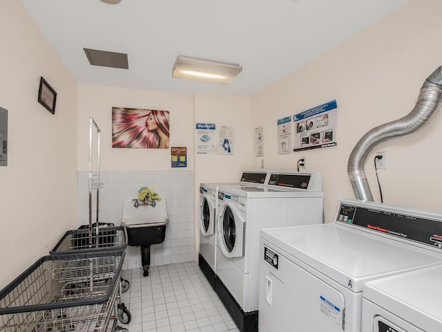 1347 Bristow St Unit 4B, Bronx, NY 10459 - shared laundry with washing machine and clothes dryer, light tile patterned floors, tile walls, and wainscoting