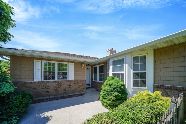 192 Theodore Dr, Coram, NY 11727 - doorway to property with brick siding and a chimney
