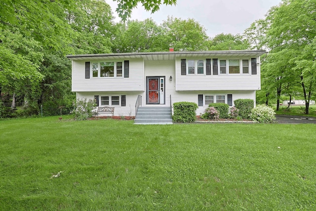 10 Cregan Pl, Monroe, NY 10950 - split foyer home featuring a front yard and a chimney