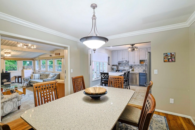10 Cregan Pl, Monroe, NY 10950 - dining space with crown molding, baseboards, light wood-type flooring, a chandelier, and lofted ceiling
