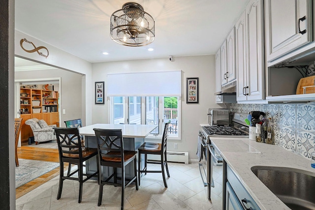 10 Cregan Pl, Monroe, NY 10950 - kitchen featuring gas range, decorative backsplash, light stone counters, a chandelier, and a baseboard radiator