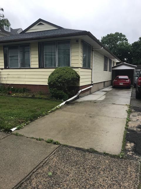 3111 Mott Ave, Far Rockaway, NY 11691 - view of home's exterior with a yard