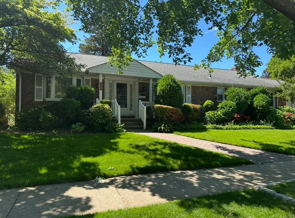 210-16 36th Ave, Bayside, NY 11361 - ranch-style home featuring a front yard