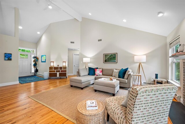 72 Greencrest Rd, Goshen, NY 10924 - living room with wood finished floors, high vaulted ceiling, beam ceiling, and baseboards