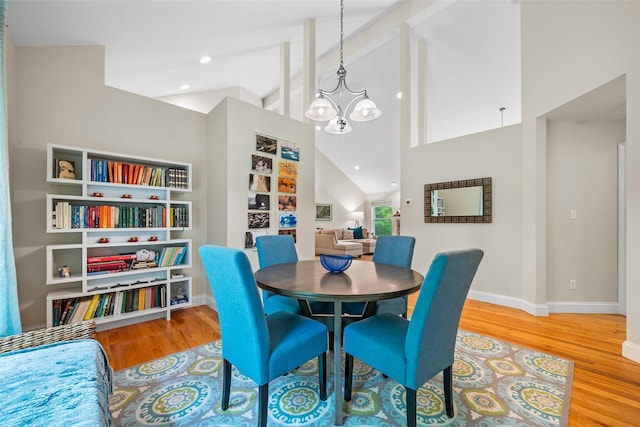72 Greencrest Rd, Goshen, NY 10924 - dining space with a chandelier, wood finished floors, baseboards, beam ceiling, and high vaulted ceiling