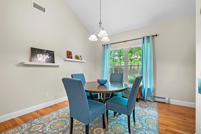 72 Greencrest Rd, Goshen, NY 10924 - dining area featuring a baseboard radiator, a chandelier, baseboards, wood finished floors, and high vaulted ceiling