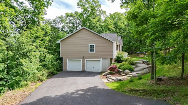 72 Greencrest Rd, Goshen, NY 10924 - view of property exterior with driveway, an attached garage, stairway, and roof with shingles