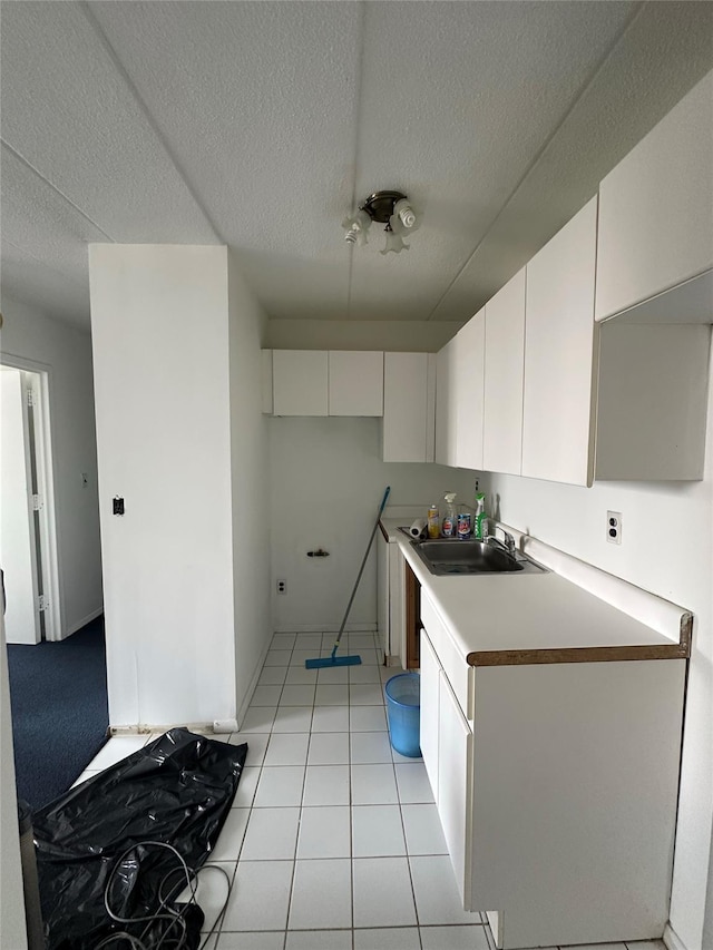 97-12 63rd Dr Unit 10D, Rego Park, NY 11374 - kitchen featuring a textured ceiling, white cabinets, light tile patterned flooring, and light countertops