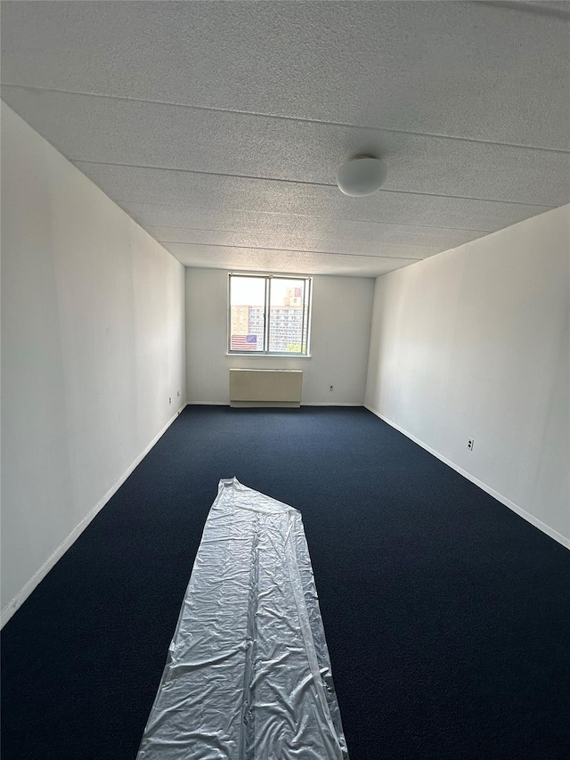 97-12 63rd Dr Unit 10D, Rego Park, NY 11374 - unfurnished room featuring dark carpet and baseboards