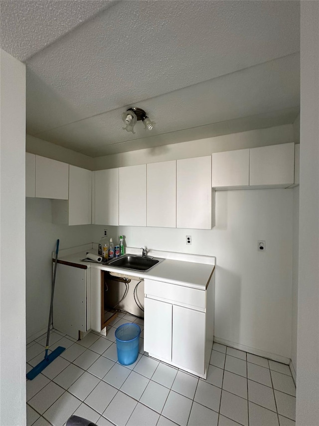 97-12 63rd Dr Unit 10D, Rego Park, NY 11374 - kitchen with white cabinets, light tile patterned flooring, a textured ceiling, and light countertops