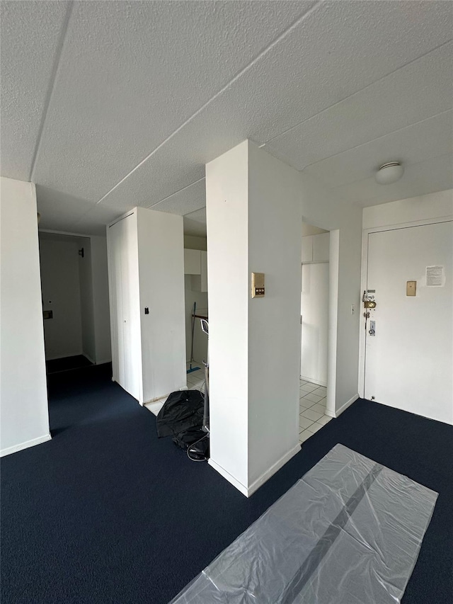 97-12 63rd Dr Unit 10D, Rego Park, NY 11374 - unfurnished bedroom with carpet flooring and a textured ceiling
