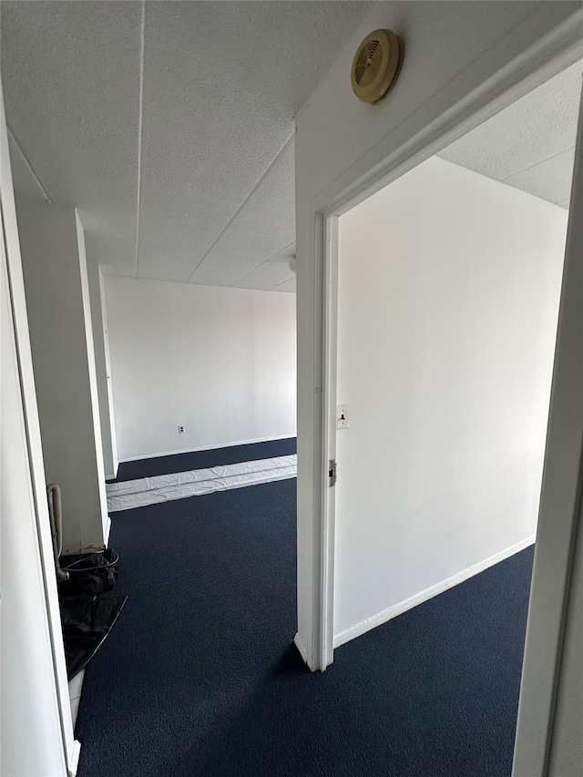 97-12 63rd Dr Unit 10D, Rego Park, NY 11374 - corridor featuring carpet floors and a textured ceiling