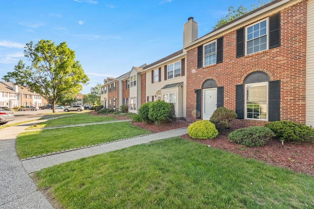 8 Moore Ln, Washingtonville, NY 10992 - view of front facade featuring a residential view, a chimney, a front lawn, and brick siding