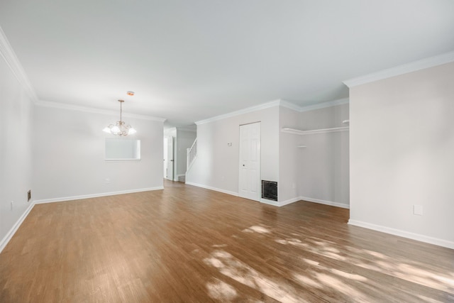 8 Moore Ln, Washingtonville, NY 10992 - unfurnished living room with wood finished floors, a chandelier, stairs, ornamental molding, and baseboards