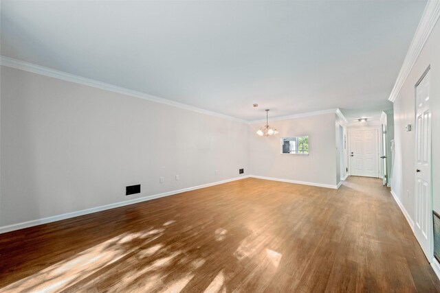 8 Moore Ln, Washingtonville, NY 10992 - unfurnished living room featuring a chandelier, wood finished floors, ornamental molding, and baseboards