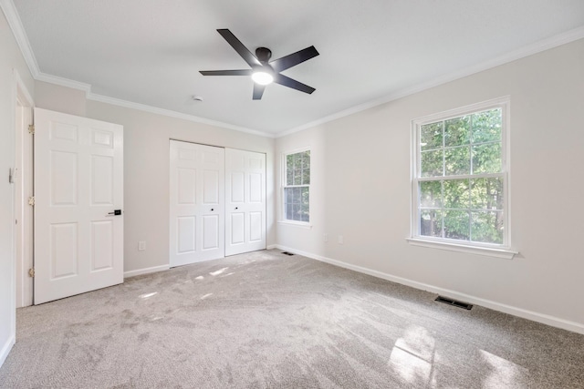 8 Moore Ln, Washingtonville, NY 10992 - unfurnished bedroom featuring multiple windows, baseboards, crown molding, a closet, and carpet floors