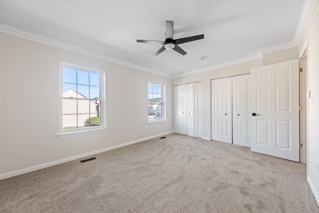 8 Moore Ln, Washingtonville, NY 10992 - unfurnished bedroom featuring multiple closets, ornamental molding, carpet, and baseboards