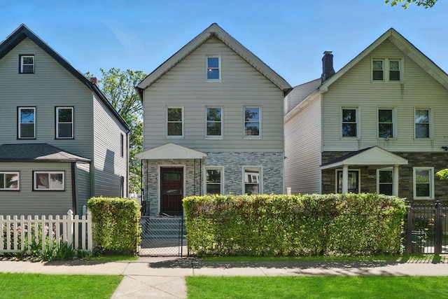 419 S 7th Ave, Mount Vernon, NY 10550 - view of front of house featuring stone siding, a fenced front yard, and a gate