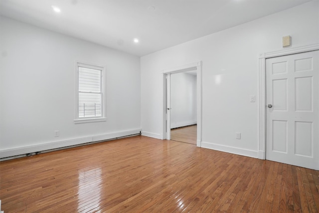419 S 7th Ave, Mount Vernon, NY 10550 - unfurnished bedroom featuring hardwood / wood-style floors, a baseboard heating unit, baseboards, and recessed lighting